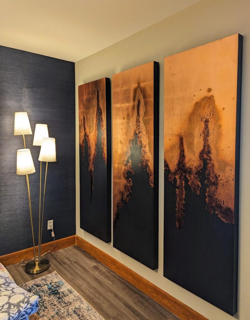 Interior design photo of large scale navy and copper wall art and floor lamp